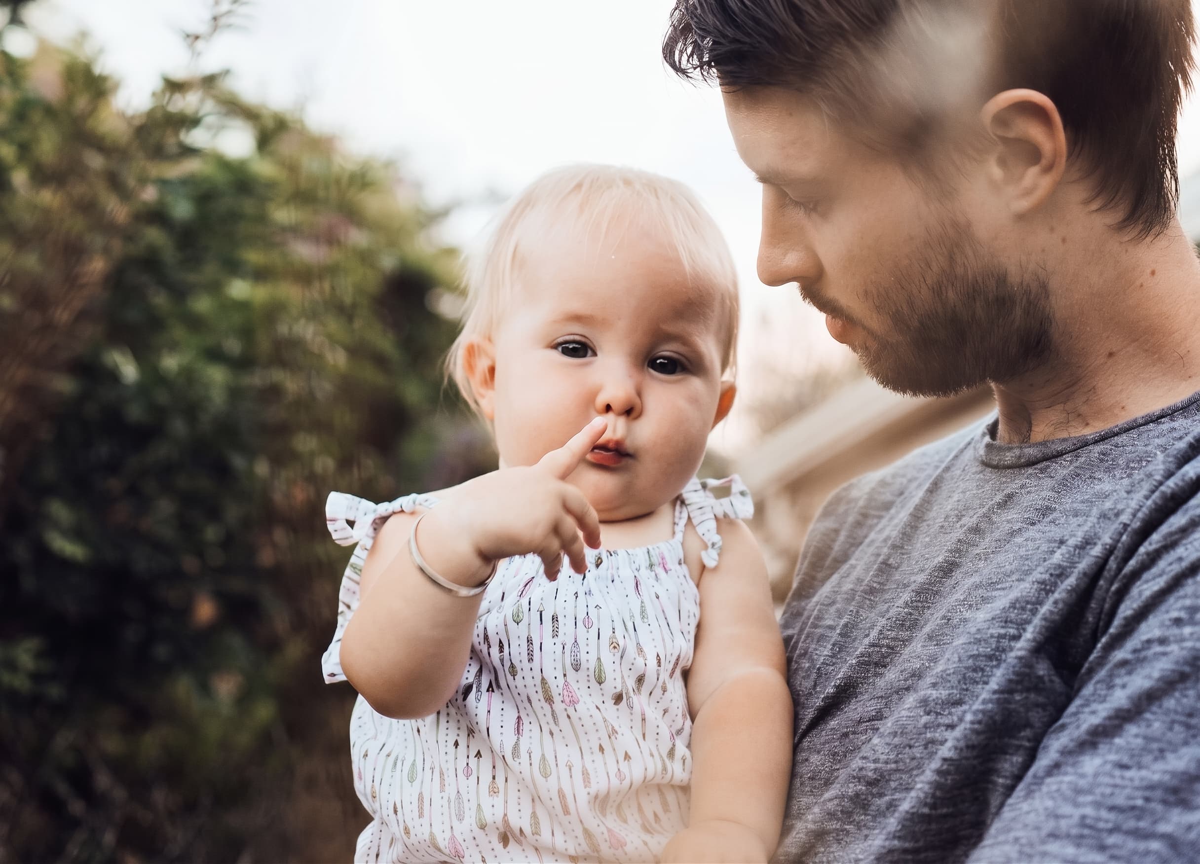 Father holding his young daughter outdoors